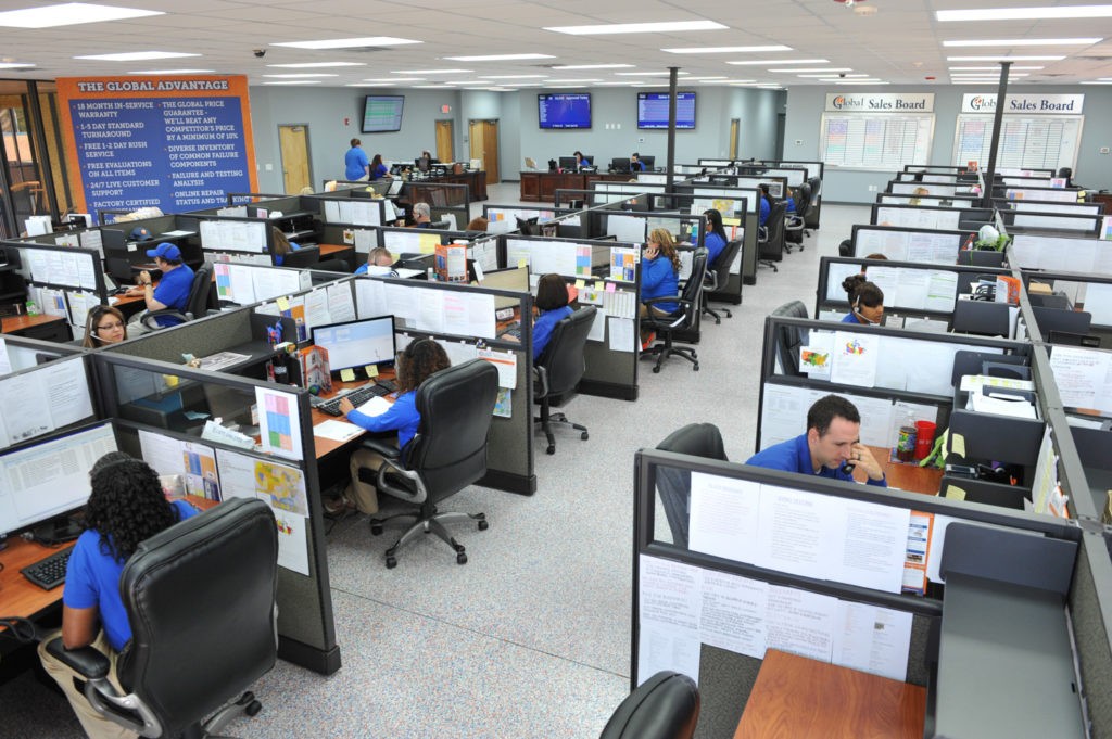 Workers inside the Global Electronic services office