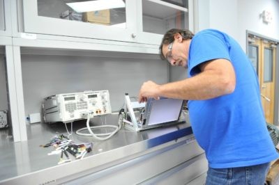 Technician repairing industrial LED monitor