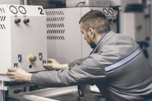 Worker Operating Welding Machine In Factory