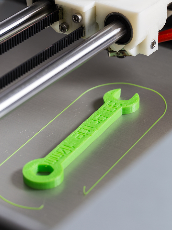 3d printing wrench with light green filament.
