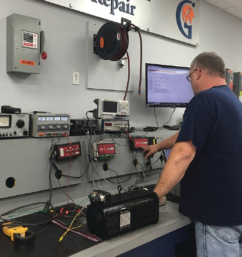 Man operating equipment in global electronic repair shop
