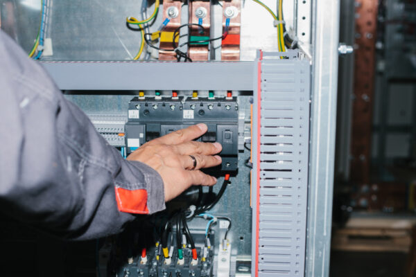 Electrician Specialist Checking Low-voltage Cabinet Equipment