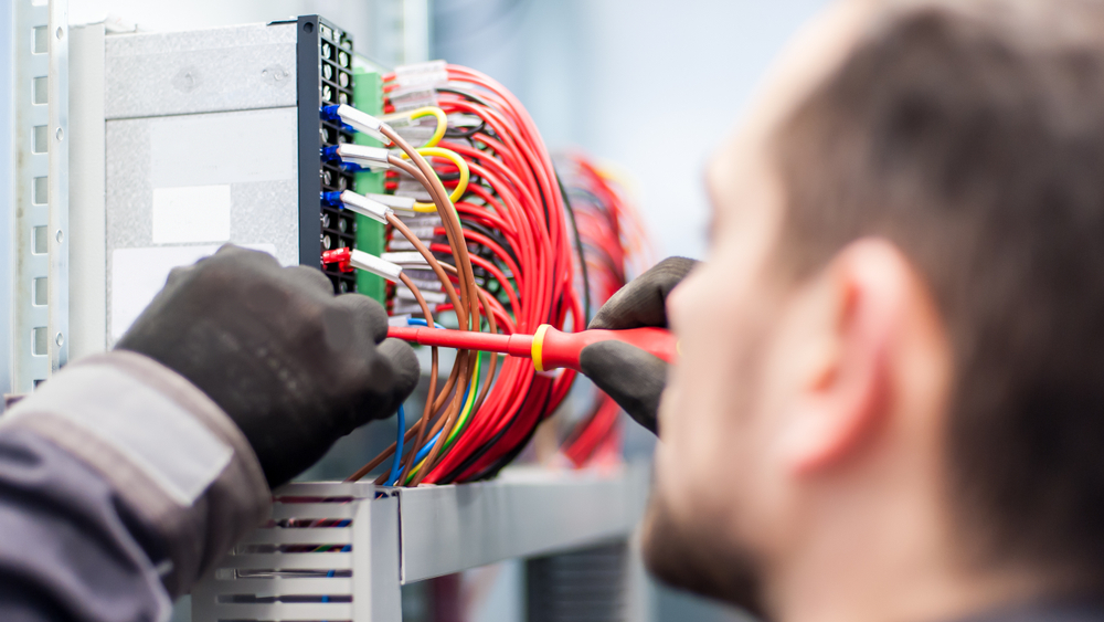 Closeup Of Electrician Engineer Working With Electric Cable Wires