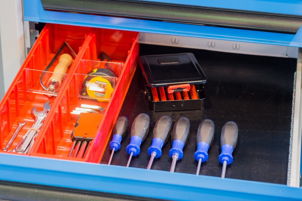 Six screwdrivers laying in a tool box