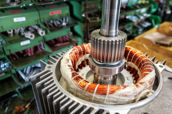 Skilled Industrial Worker Assembling Electric Motor