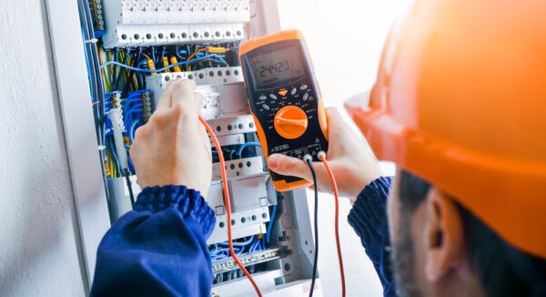 Electrician Installing Electric Cable Wires And Fuse Switch Box