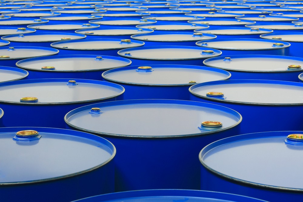 A field full of blue oil tanks 