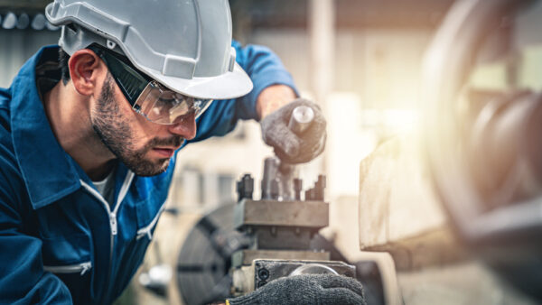Engineer In Blue Jumpsuit And White Hard Hat
