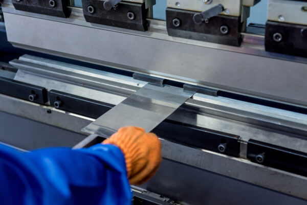 A Technician Operator Uses A Hydraulic Bending Machine