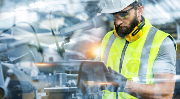 Industrial Engineer Working With Robotic Arm