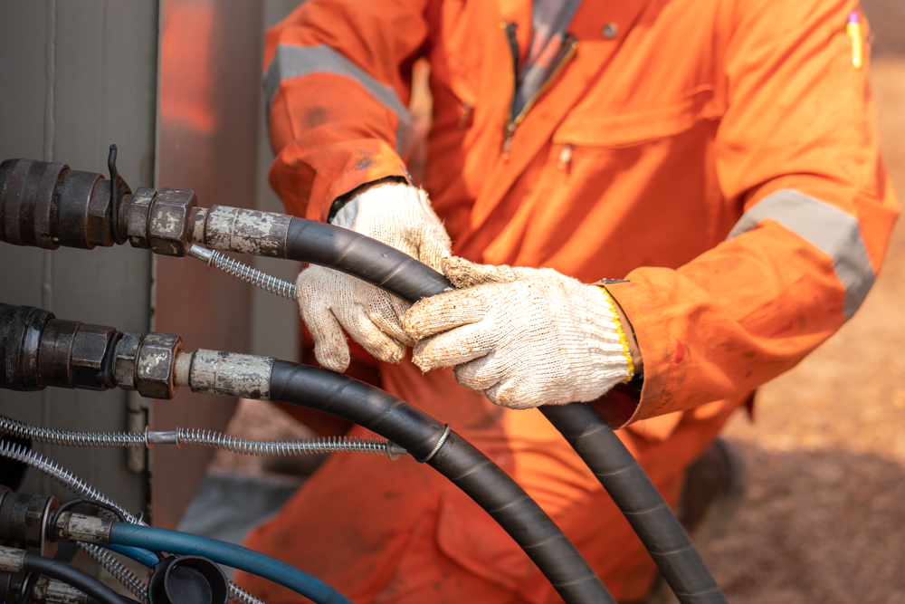 Worker Hand Is Connecting And Checking High-pressure hose