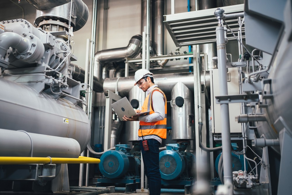 Professional Worker Of Modern Factory Using Laptop