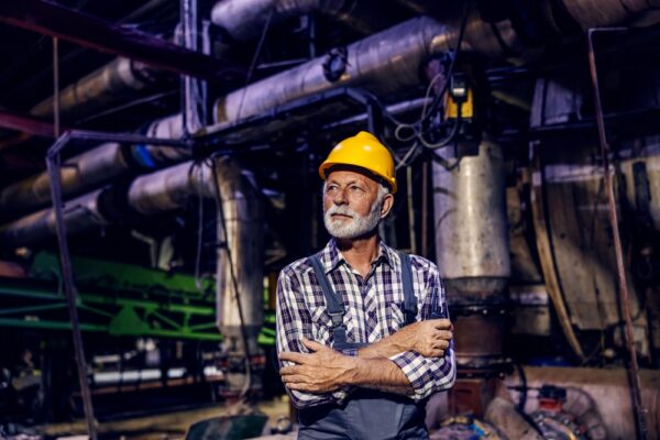 A Successful Senior Factory Worker With A Helmet