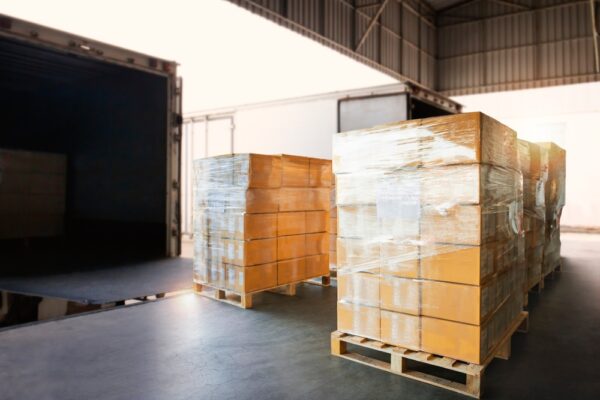 Packaging Boxes Wrapped Plastic On Pallets Loading Into Cargo Container.