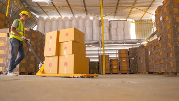 Worker Unloading Cardboard Boxes