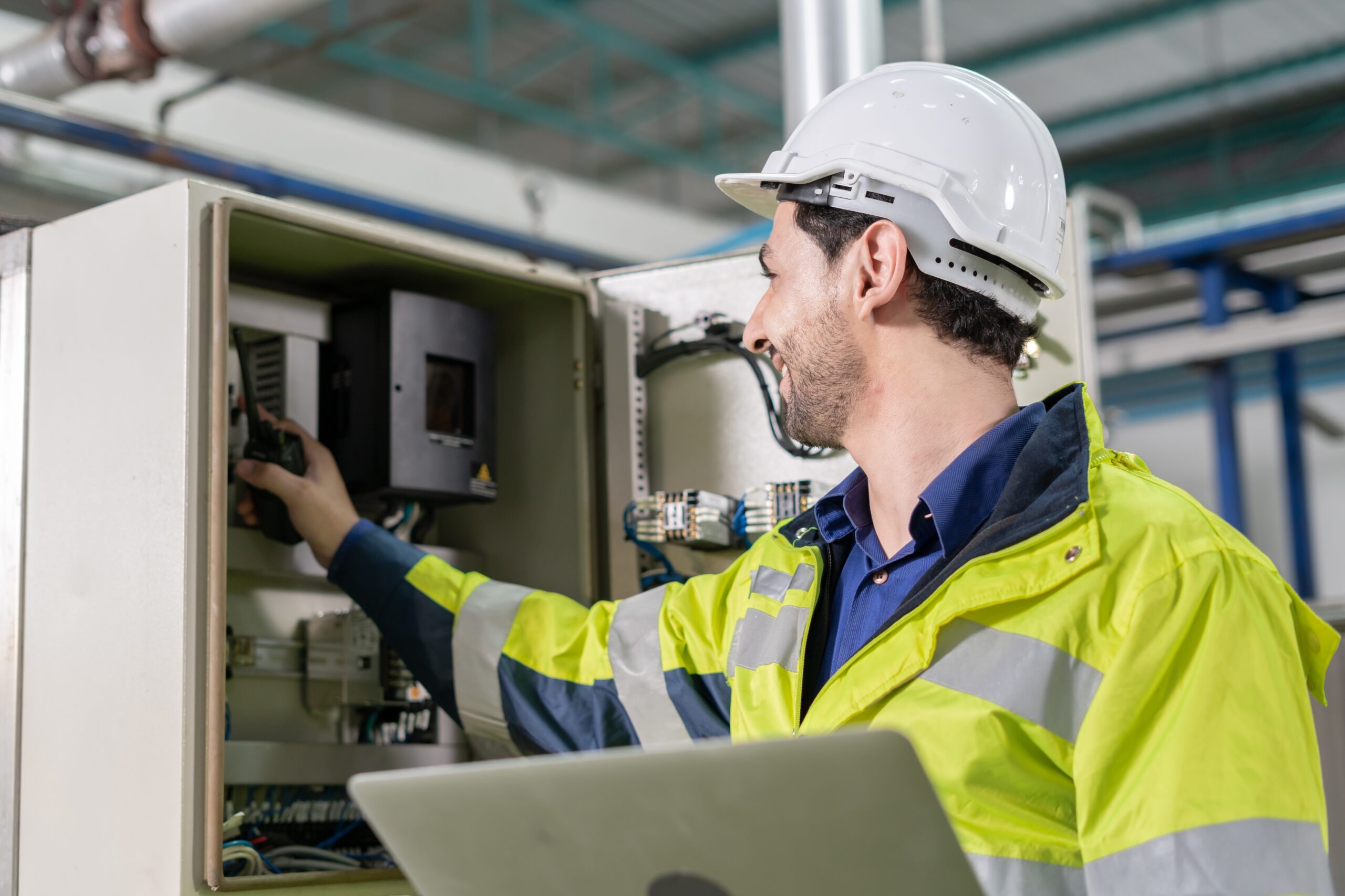 Mechanic or maintenance or electrical engineer checking main electrical control systems industrial plant. Utility fore man daily check power systems in process.