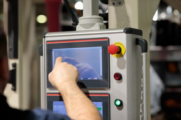 Operator Working With Touchscreen Control Panel Of Industrial Machine