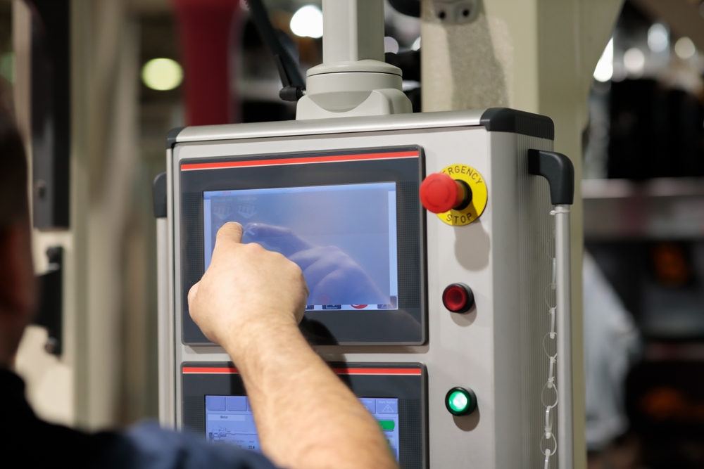 Operator Working With Touchscreen Control Panel Of Industrial Machine