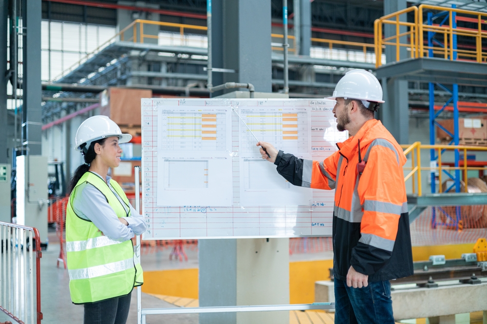 Two Engineers Discussing Production Planning Efficiency