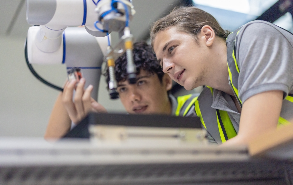 Trainees Intensely Focused On Robot Arm