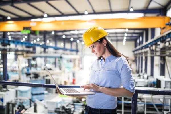 Female Project Manager Standing In Modern Industrial Factory. Manufacturing Facility