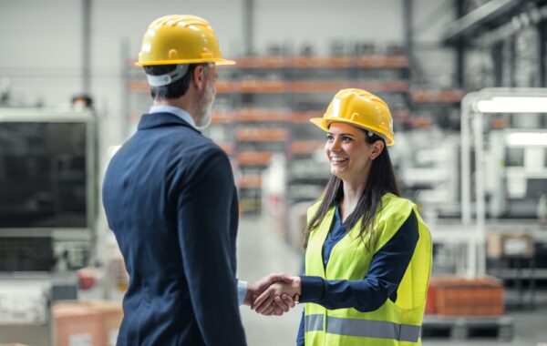 Warehouse Worker Shaking Hand With Logistics Employee In Warehouse