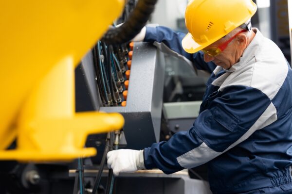 Worker Checks Hydraulic Hose Valves