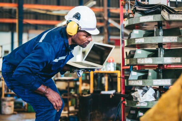 Industrial Technician Monitoring Factory's Inventory Operation