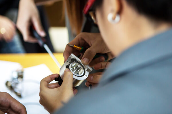 A Young Engineer And Technician Working With Encoder