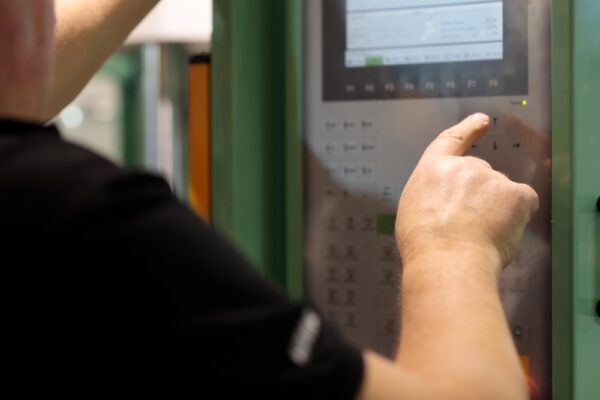 Operator Controls Machine With Control Panel