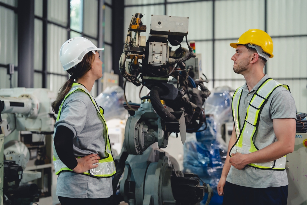 Technician Engineer In Factory Maintaining And Repairing Robotic Arms