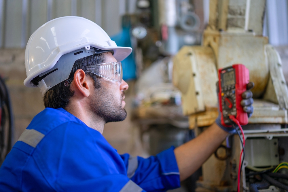 Blue Collar Workers At Machine Shop With Welding Robot Arm