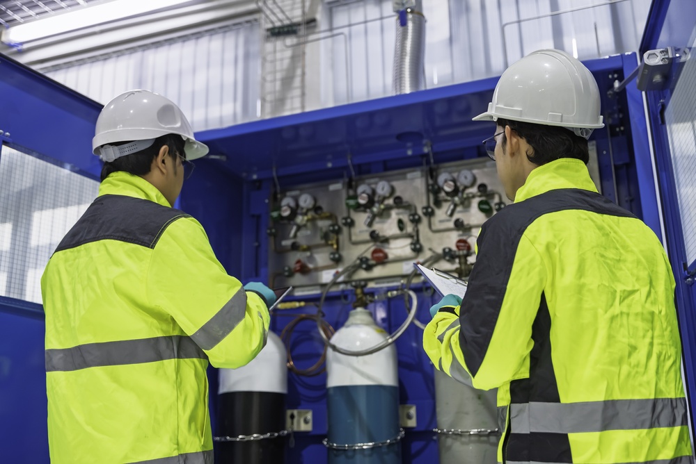 Professional Engineers Inspecting Industrial Gas Control System