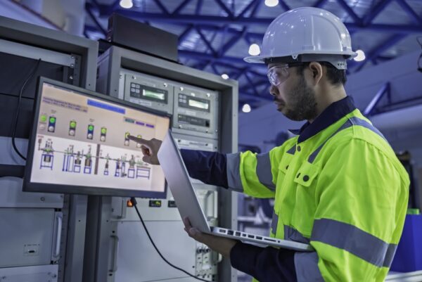 Technician Holding A Laptop While Inspecting