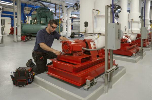 Workman Repairing Electric Motor In Building Transformer Underground