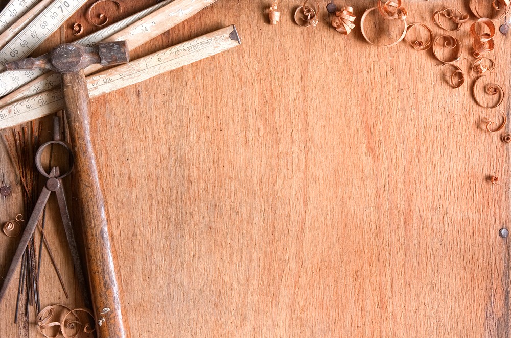 composition of grungy old hand tools on a wood surface